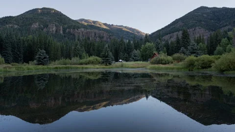 Mountain pond reflection at sunrise timelapse Stock-Footage 348024039
