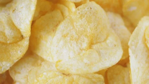 A mountain of potato chips lies on the table. Golden chips close-up. Lots of Stock-Footage 219964862