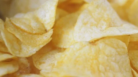 A mountain of potato chips lies on the table. Golden chips close-up. Lots of Stock-Footage 220038985