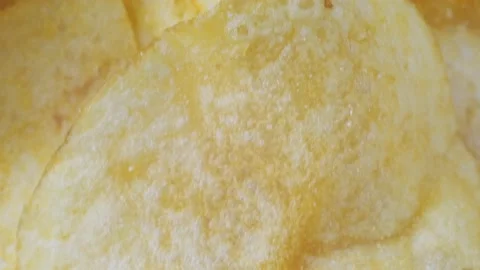 A mountain of potato chips lies on the table. Golden chips close-up. Lots of Stock-Footage 220341675