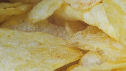 A mountain of potato chips lies on the table. Golden chips close-up. Lots of Stock-Footage 220746942