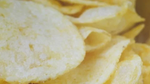 A mountain of potato chips lies on the table. Golden chips close-up. Lots of Stock-Footage 221152168