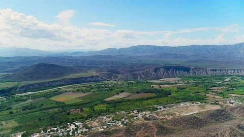 Mountain range against a blue sky with white clouds. Stock Footage 232948503
