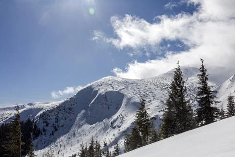 Mountain range and avalanche dangerous terrain in snowy mountains Stock Photos