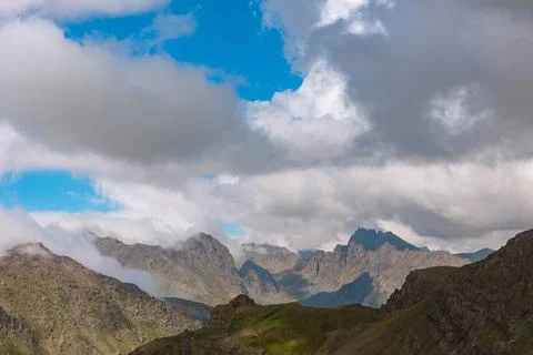 Mountain range and clouds or fog. Landscape of mountain peaks. Stock Photos