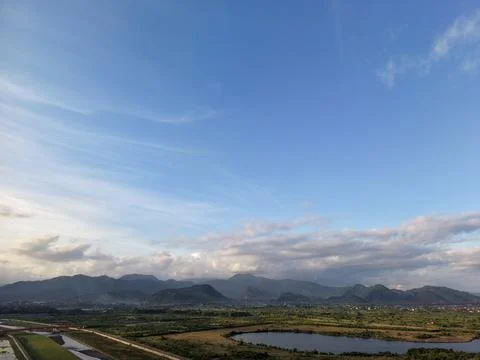 Mountain Range and Green Fields Under Blue Sky in Karangasem Bali Fotos Stock