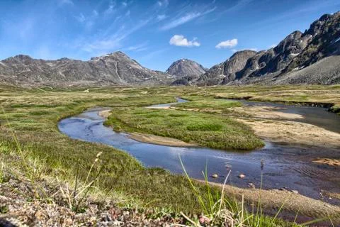 Mountain range and river bed in summer Stock Photos