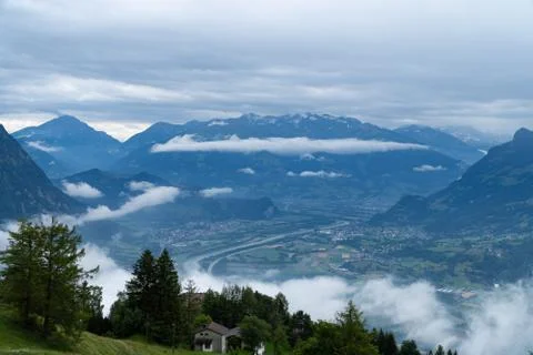 A mountain range and a valley in the clouds - blue colors Stock Photos