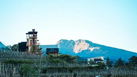 A mountain range is in the background of a small town Stock Photos