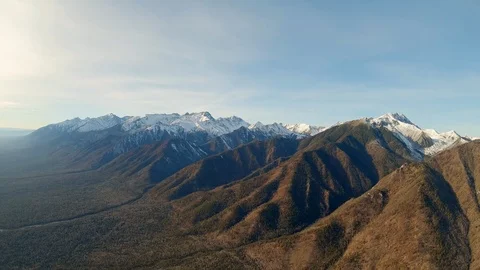 Mountain range from a bird's eye view. Aerial view of snow-capped mountain peaks Stock Footage 126964435