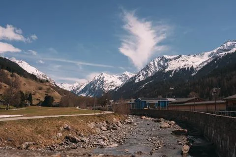 A mountain range with a blue building in the distance Stock Photos
