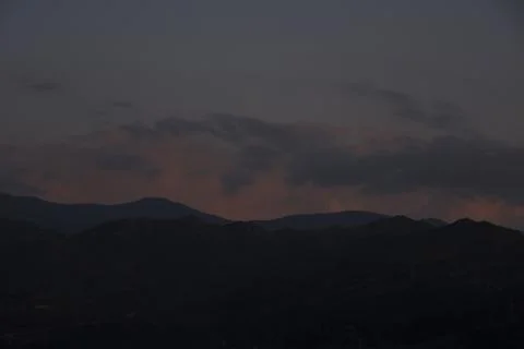 Mountain range blue shapes at sunset Stock Photos