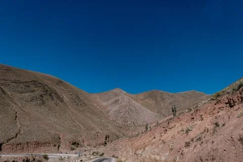 A mountain range with a blue sky in the background Stock Photos