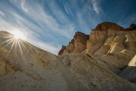 A mountain range with a bright sun shining on it Stock Photos
