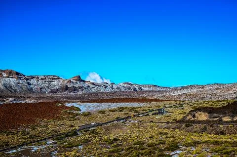 A mountain range with a clear blue sky in the background Stock Photos
