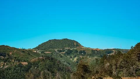 A mountain range with a clear blue sky in the background Stock Photos