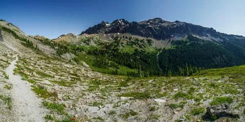 A mountain range with a clear blue sky in the background Stock Photos