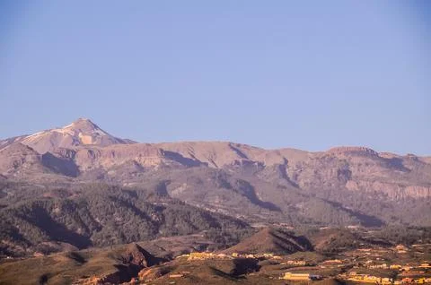 A mountain range with a clear blue sky in the background Stock Photos