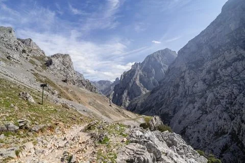 A mountain range with a clear blue sky and a few clouds. Cares Route. Stock Photos