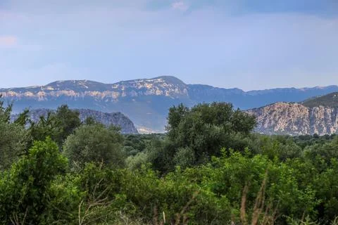 A mountain range with a clear blue sky in the background on the island Sard.. Stock Photos