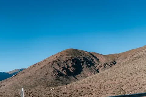 A mountain range with a clear blue sky in the background Stock-Fotos