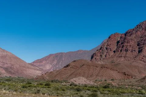 A mountain range with a clear blue sky in the background Stock Photos