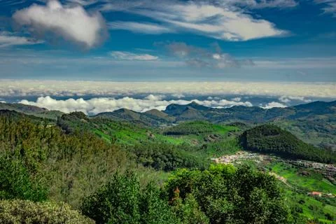 Mountain range with cloud layers and green forest 写真素材