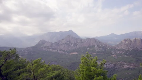 Mountain range clouded in mist on a cloudy day Stock Footage 203960298
