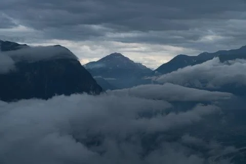 A mountain range in the clouds - blue colors Stock Photos