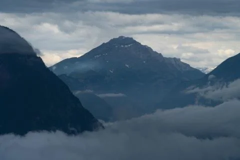 A mountain range in the clouds - blue colors Stock Photos