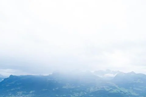 A mountain range in the clouds - blue colors Stock Photos