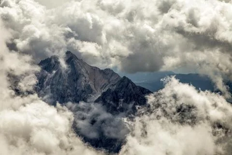 A mountain range with clouds in the sky view of the alps from zugspitze mountain Stock Photos