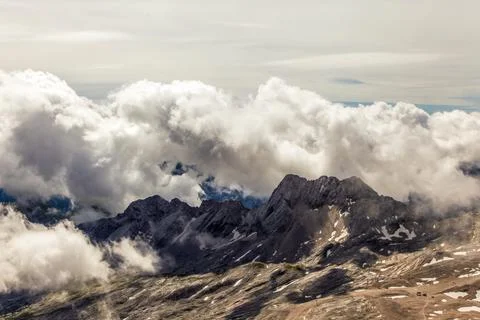 A mountain range with clouds in the sky view of the alps from zugspitze mountain Stock Photos