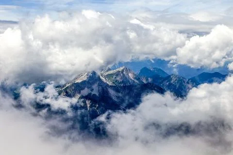 A mountain range with clouds in the sky view of the alps from zugspitze mountain Stock Photos