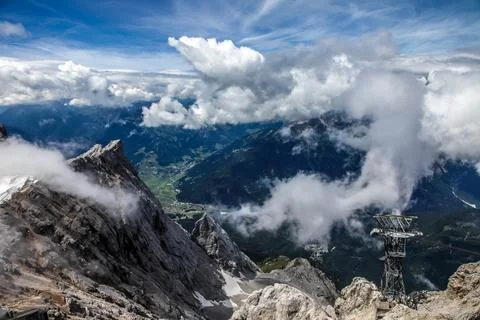 A mountain range with clouds in the sky view of the alps from zugspitze mountain Stock Photos