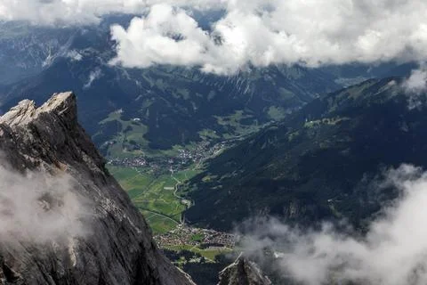 A mountain range with clouds in the sky view of the alps from zugspitze mountain Stock Photos