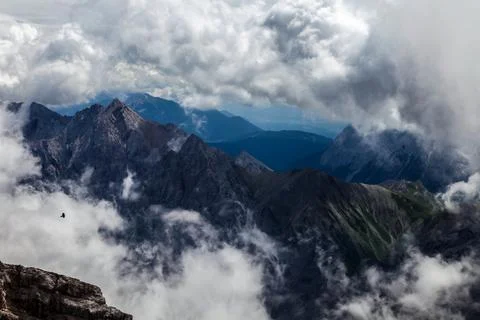 A mountain range with clouds in the sky view of the alps from zugspitze mountain Stock-Fotos