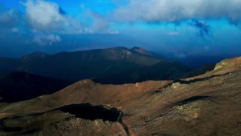 A mountain range with a cloudy sky in the background Stock Footage 327911970