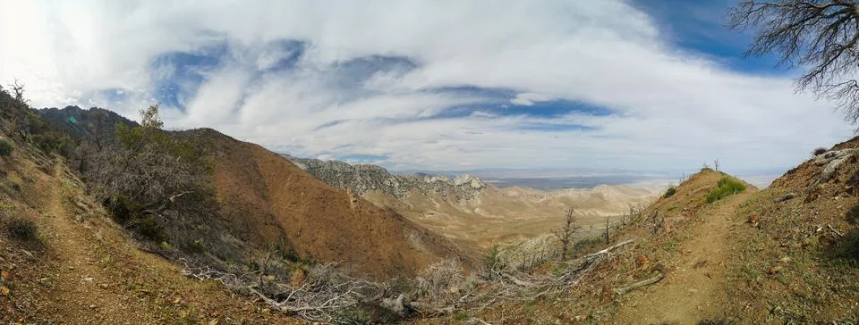 A mountain range with a cloudy sky in the background Stock Photos
