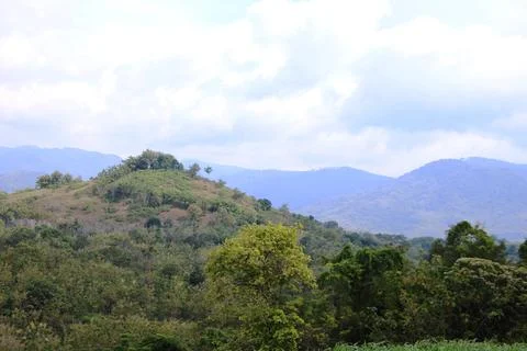 A mountain range with a cloudy sky in the background Stock Photos