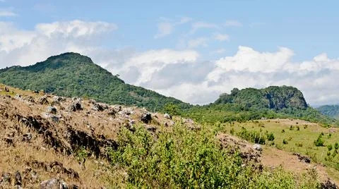 A mountain range with a cloudy sky in the background Stock Photos