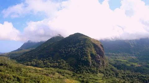 A mountain range with a cloudy sky in the background Stock Photos