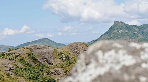 A mountain range with a cloudy sky in the background Stock Photos