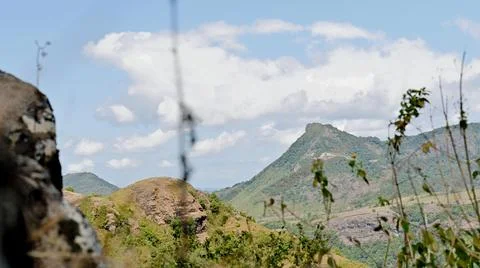 A mountain range with a cloudy sky in the background Stock Photos