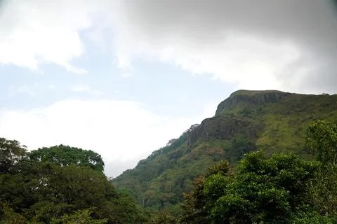 A mountain range with a cloudy sky in the background Stock Photos