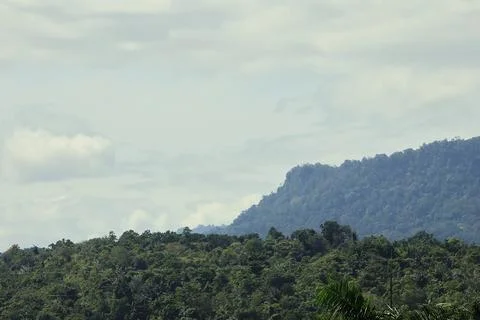 A mountain range with a cloudy sky in the background Stock Photos