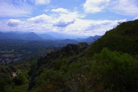 A mountain range with a cloudy sky in the background Stock Photos