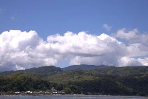 A mountain range with a cloudy sky in the background Stock Photos