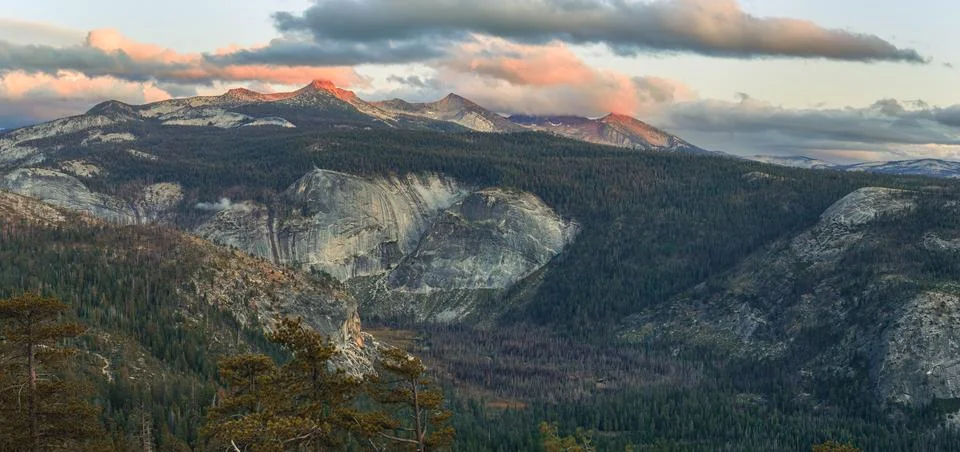 A mountain range with a cloudy sky in the background Stock Photos