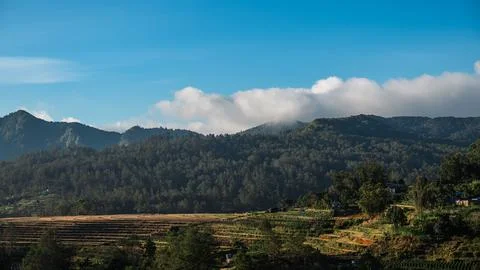 A mountain range with a cloudy sky in the background. Malino Indonesia Stock Photos
